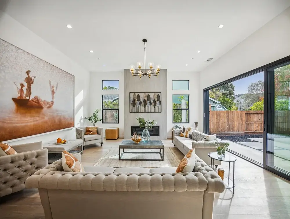 Open-plan living room with sliding glass doors onto the backyard in a Central Florida home, remodeled by Global Arch Construction of Orlando, FL